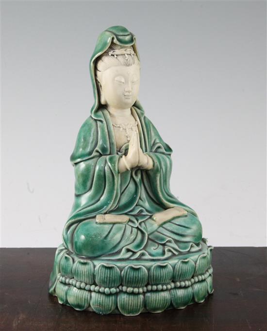 A Chinese green glazed biscuit porcelain seated figure of Guanyin, 12cm